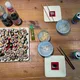 Table filled with a vegan sushi plate, some plates, drinks and a baby monitor