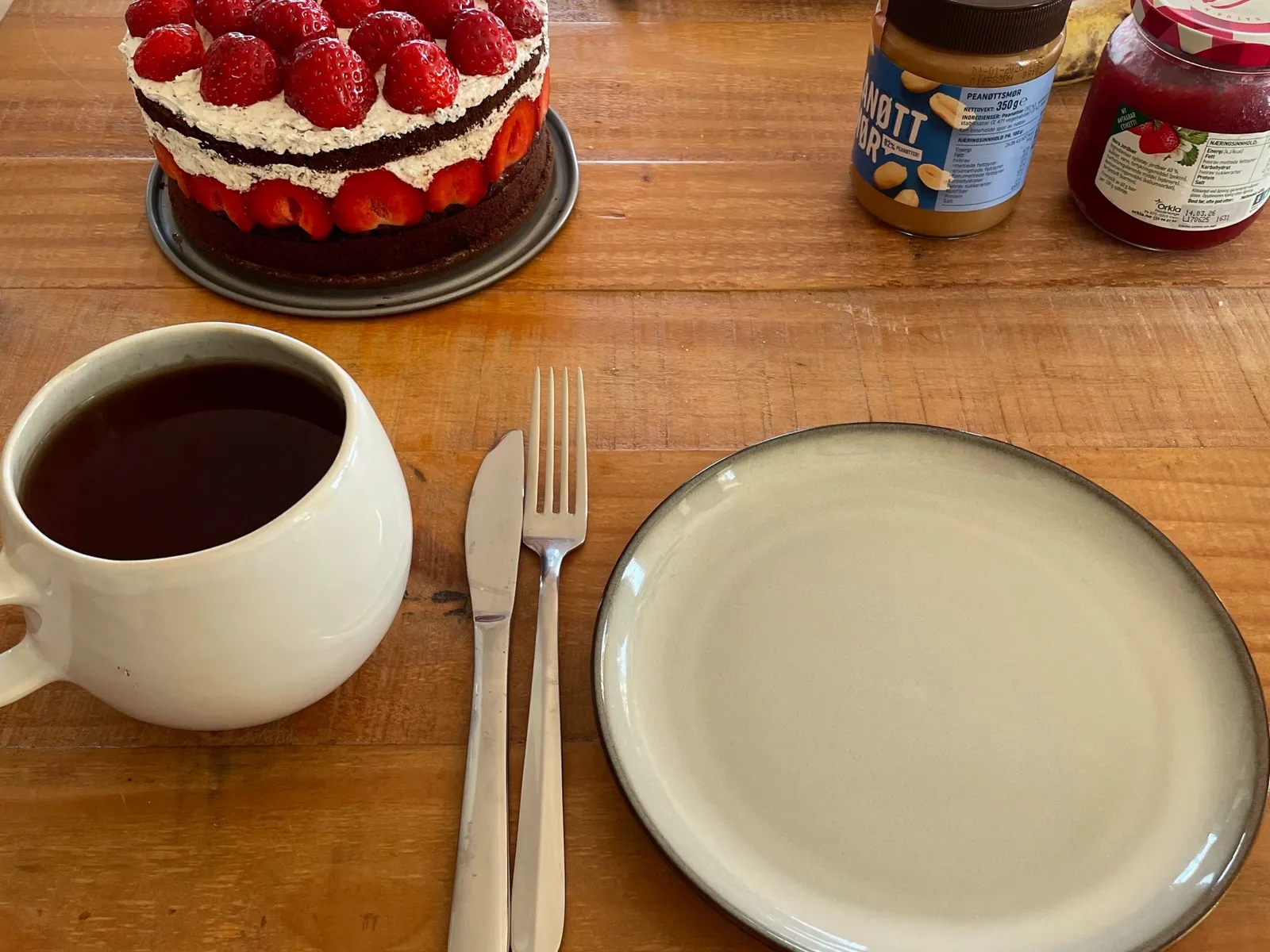 Strawberry cake and pancakes on a table