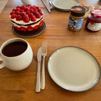 Strawberry cake and pancakes on a table