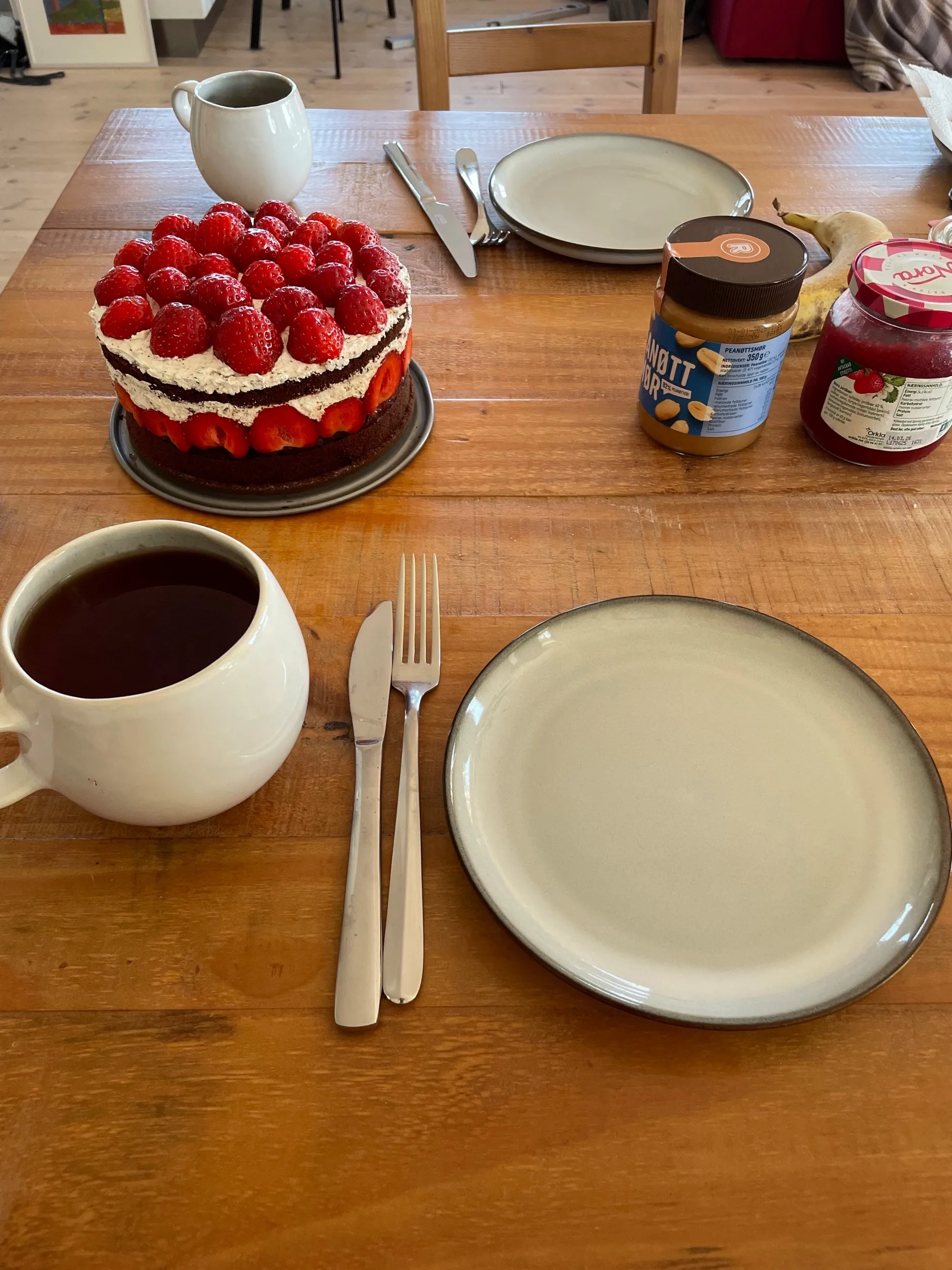 Strawberry cake and pancakes on a table