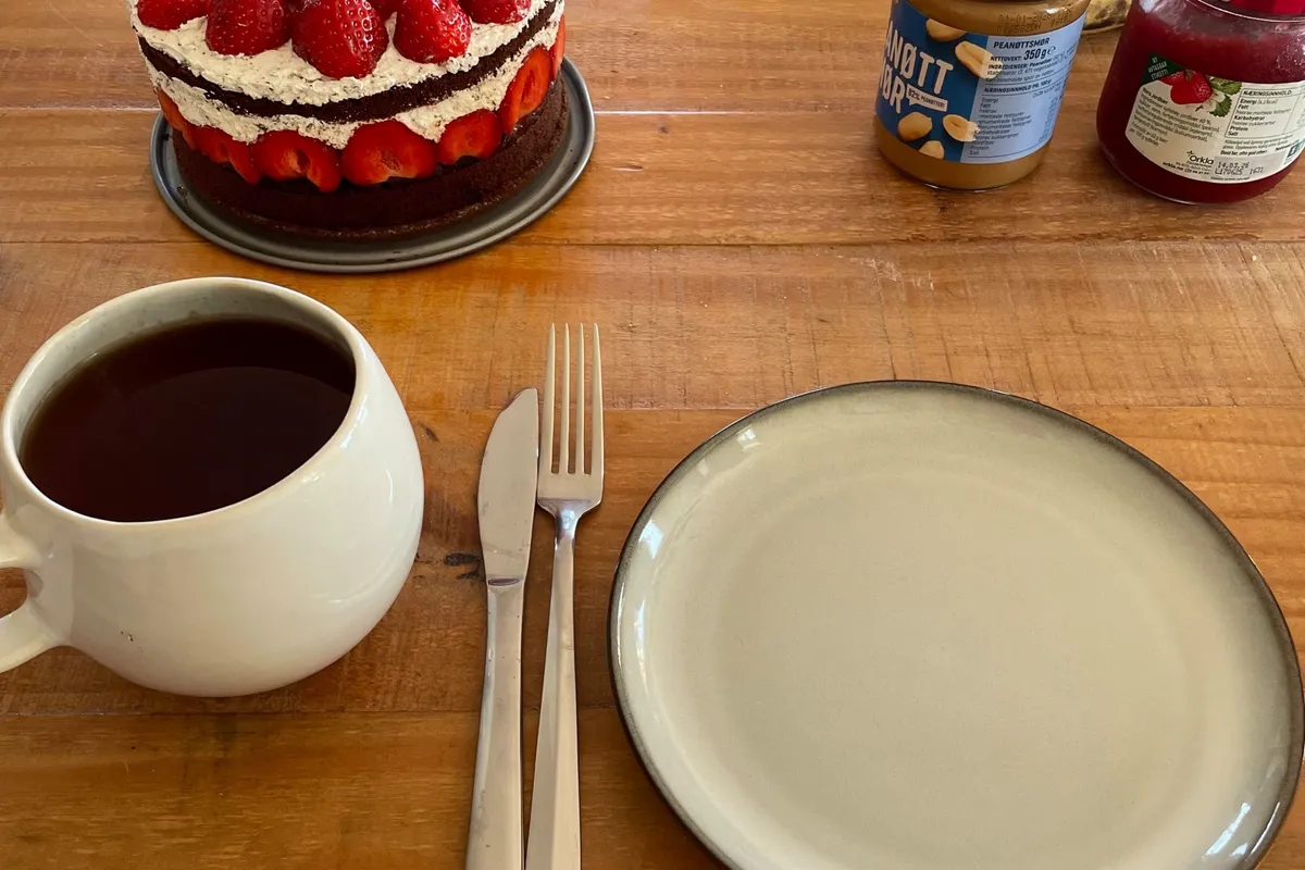 Strawberry cake and pancakes on a table
